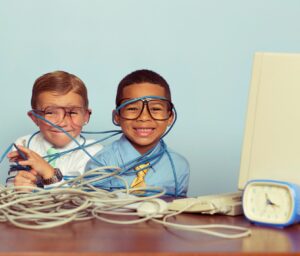 Young Boys and IT Professionals Smile at Computer Desk